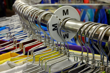 Colored Shirts on Hangers Set on Rack to Sell in Store
