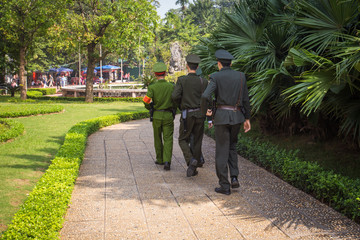 Three soldiers marching through the park in Hanoi, Vietnam