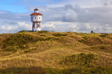 Fototapeta na wymiar A lighthouse at the island of Langeoog, Lower Saxony, Germany