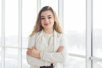 Beautiful young woman by window