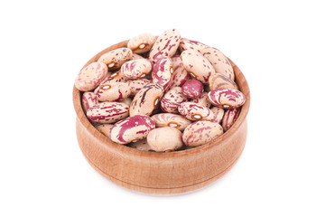 Pinto beans in a wooden bowl isolated on white background