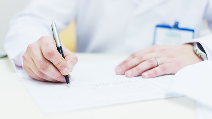 Male doctor hands on the table