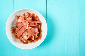 Fresh Bacon In White Bowl On Turquoise Table