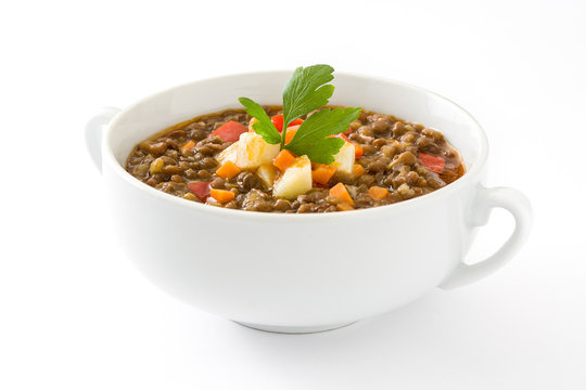 Lentil soup in a bowl, isolated on white background
