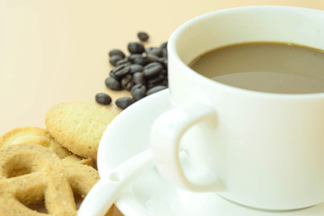 Coffee cup and coffee beans on Orange background.