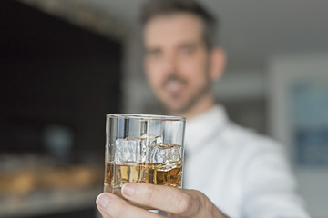 Man holding up his drink to toast