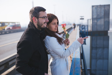 Happy attractive couple enjoying city outdoors. People in love and Valentine's day theme. 