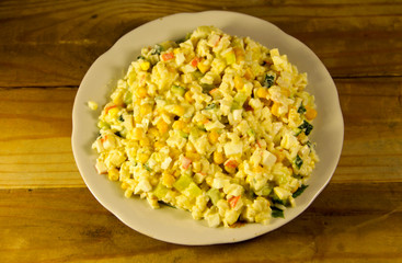 Salad with crab sticks sweet corn cucumber eggs and rice