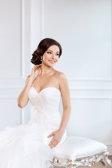 Fototapeta na wymiar Beautiful bride. Wedding hairstyle make-up luxury fashion dress concept