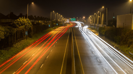 Car light trails on the highway in the early morning rush hour 