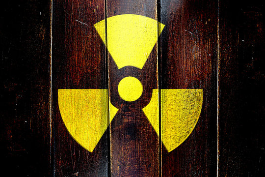 Vintage Radioactive warning on a grunge wooden panel