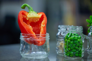 Fototapeta na wymiar Food ingredients in jars vegetables, Red pepper, peas