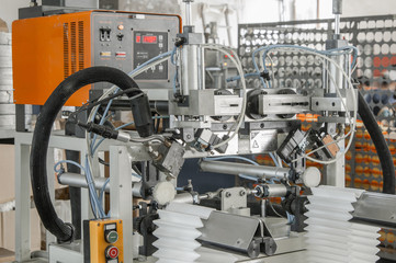 closeup of the machine and equipment are cut and furrowing the felt fabric for automotive filters