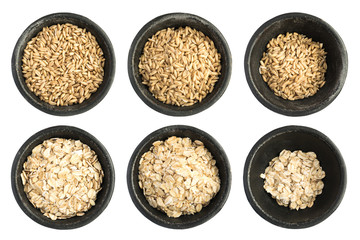 Set Raw Dry Oat Flakes Grains Heap in Black Iron Bowl