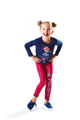 Pretty blondie six years old small girl on white background dancing and showing tongue