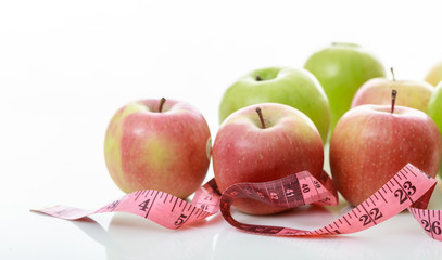 Apples and measure tape on white background