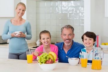 Happy family having breakfast in kitchen