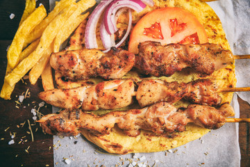 Meat skewers on a wooden background