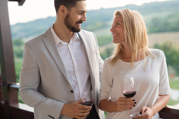 People sampling and tasting wines in vineyard