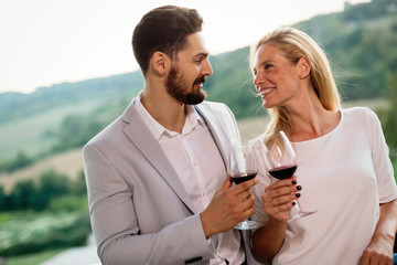 People sampling and tasting wines in vineyard