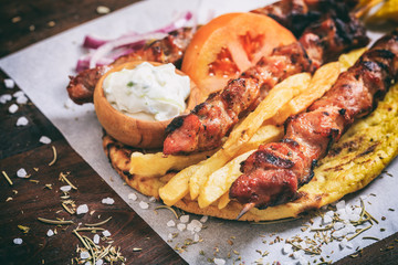 Meat skewers on a wooden background