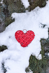 red handmade heart on branches