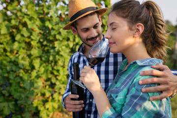 People tasting wine in vineyard