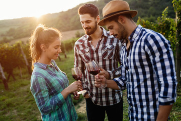 People tasting wine in vineyard