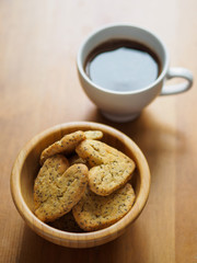 heart shape cookies of hearts and a cup of black coffee