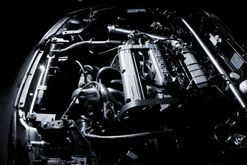 Details of engine close up on black background.