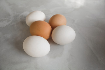 white and brown eggs on a white marble table