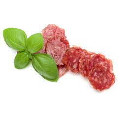 Salami smoked sausage slices and basil leaves isolated on white