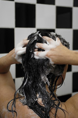 Naklejka premium Woman on her back washing her hair