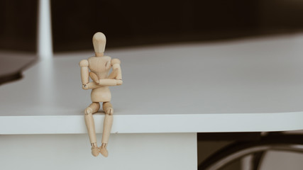 Wooden Man - Lonely figure sitting alone