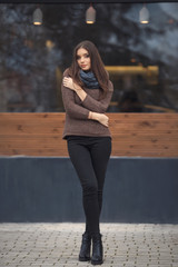 Fototapeta premium Portrait of beautiful young student woman resting near the new cafe 