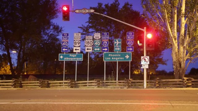 Flagstaff, Arizona - October, 2012 - Time-lapse of Historic Route 66 at dawn with traffic streaking in front of flashing signals and signs.