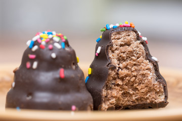 Bitten delicious chocolate cream cake on the plate