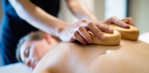 Obraz na płótnie Canvas Cliend enjoying massage given by masseur
