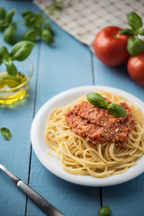 Traditional Italian spaghetti bolognese on wooden background
