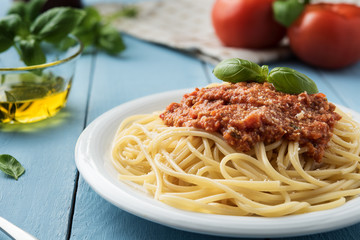 Traditional Italian spaghetti bolognese on wooden background