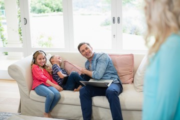 Father and kids having fun in living room