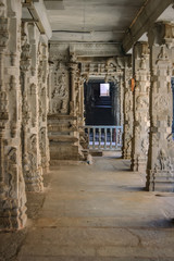 Fototapeta na wymiar Columns with the frescoes in the Shiva Virupaksha Temple. There is the famous Indian landmark located in the ruins of Vijayanagar at Hampi, India. Selective focus