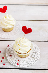 Cupcakes with red hearts for St. Valentines Day.White wooden background.