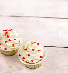 Cupcakes with red hearts for St. Valentines Day.White wooden background.