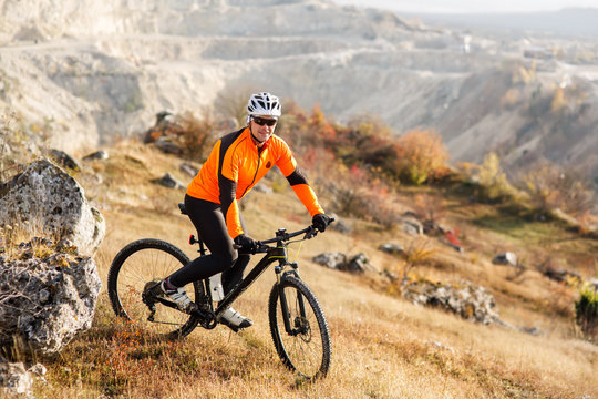 Mountain cyclist riding single track in valley