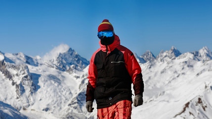 Fototapeta na wymiar snowboarder on a background of mountains Dombai