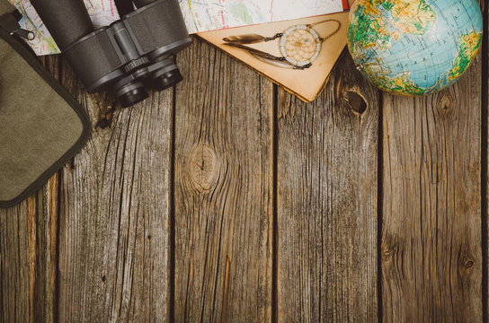 Accessories for travel top view on wooden background with copy space. Adventure and wanderlust concept image with travel accessories. Preparing for an exotic trip, journey and sightseeing.