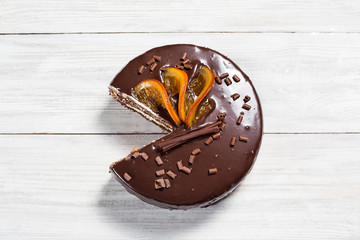 chocolate cake with Candied Oranges,Chocolate cake with a cut piece and blade on gray background, closeup,Dark chocolate cake,Delicious vegan chocolate cake,Tasty chocolate cake on wooden background