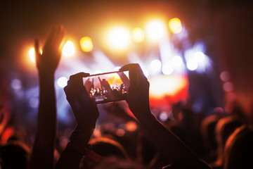 Crowd at concert recording atmosphere with their smart phones. - obrazy, fototapety, plakaty