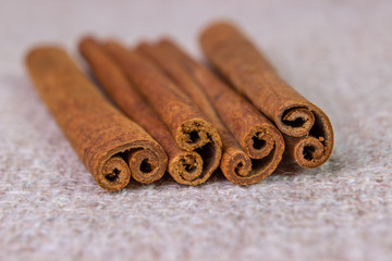 Four cinnamon sticks on sacking close-up